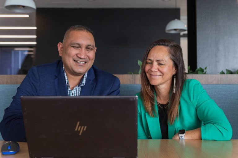 Two people working on a laptop - business