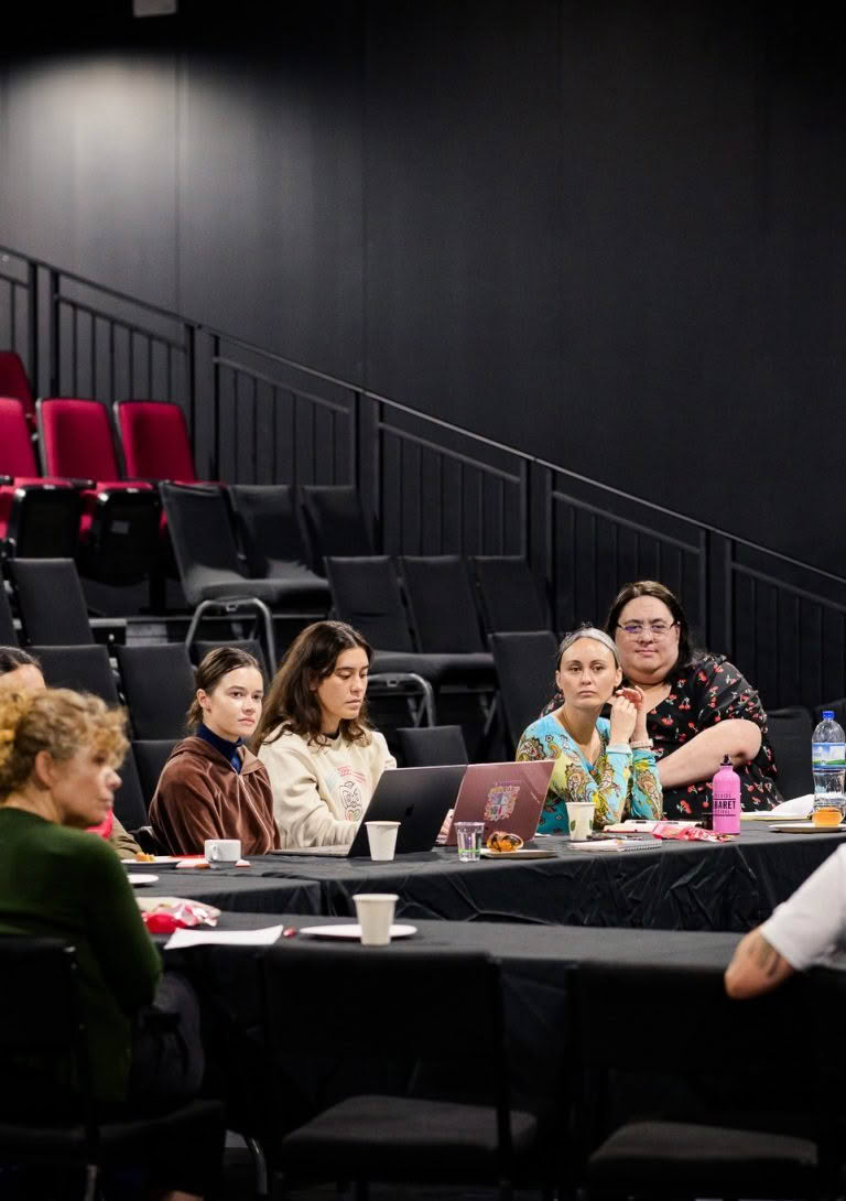 Several individuals gathered around a table in a conference room, engaged in a meeting about an accounting client.